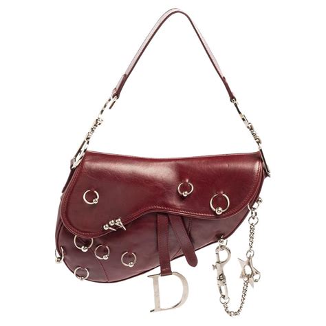 dior cherry red saddle bag|Dior pierced saddle bag.